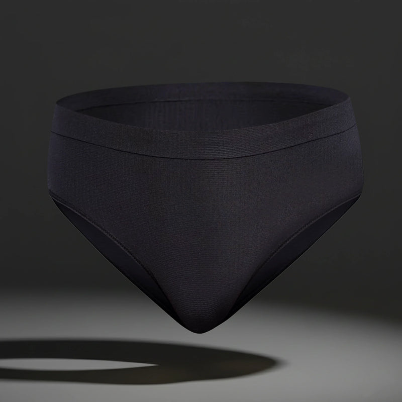 Black seamless women's femtech underwear with moisture control fabric on dark background