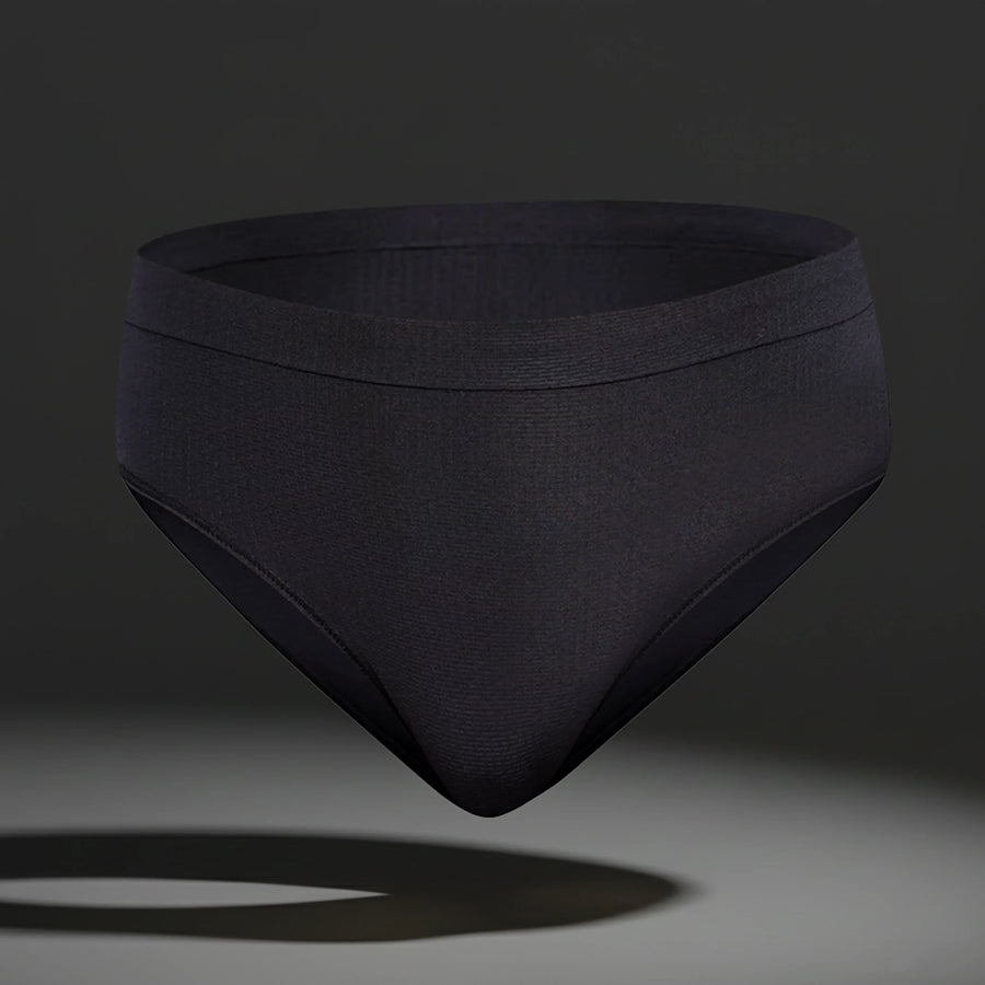 Black seamless women's femtech underwear with moisture control fabric on dark background